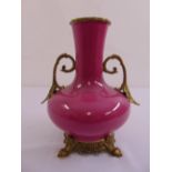 A Chinese pink glazed baluster vase with gilt metal side handle, collar and raised base, marks to