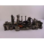 A quantity of pewter to include trays, dishes, candlesticks and containers