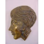 A cast brass profile of a lady