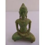 An oriental bronze seated Buddha on rectangular plinth