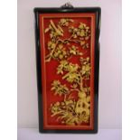 A far eastern rectangular panel carved in relief with gilded birds, trees and flowers against a