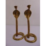 A pair of cast brass Indian candlesticks in the form of cobras