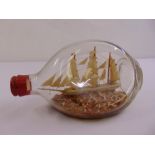 A three mast model of a ship in a Dimple Haig bottle