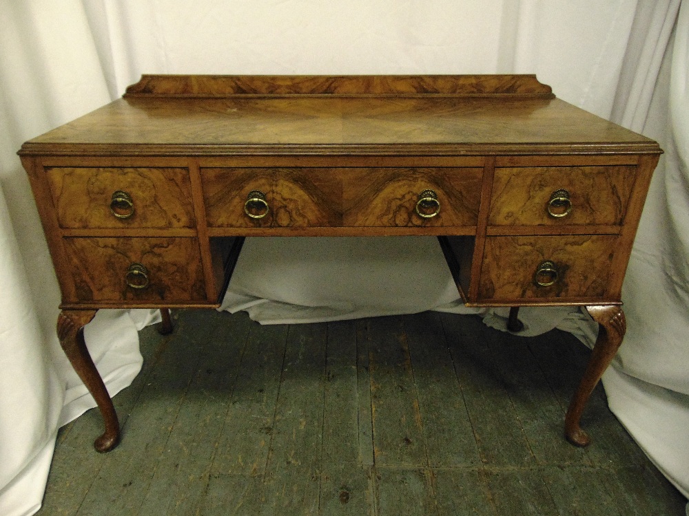 A late Victorian walnut rectangular dressing table with five drawers on cabriole legs