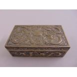 A Chinese white metal rectangular casket profusely chased with dragons to the sides and hinged