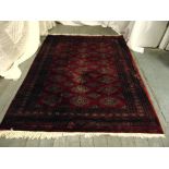 A Persian wool carpet red ground with geometric patterns and border, 231 x 176cm