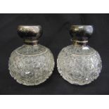 A pair of cut glass globular scent bottles with silver collars and covers, Birmingham 1916