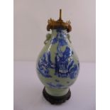 A Chinese 19th century green ground pear shaped vase decorated with figures in a landscape on carved