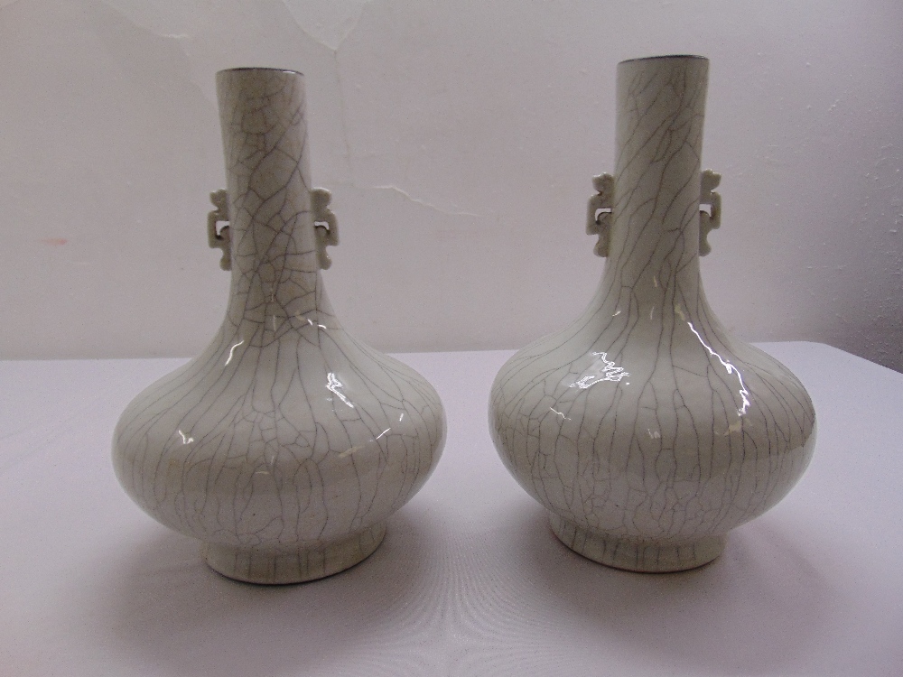 A pair of Chinese Ge type crackle glaze vases, Qianlong marks to the bases, on carved pierced