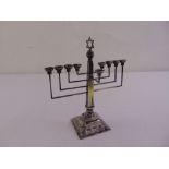 A silver Menorah, tapering rectangular stem on raised square base with beaded borders, London 1951