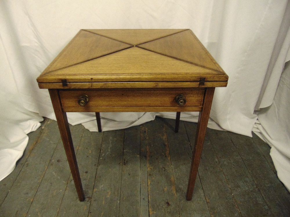 An Edwardian oak square envelope card table with single drawer on four tapering rectangular legs