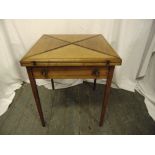 An Edwardian oak square envelope card table with single drawer on four tapering rectangular legs