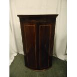 A 19th century mahogany inlaid wall mounted corner cabinet with hinged doors
