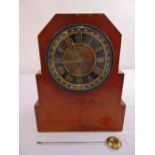 An Art Deco wooden mantle clock two train movement, silvered dial, enamel chapter ring with Roman