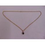 9ct yellow gold and garnet pendant on a 9ct yellow gold chain, approx total weight 3.4g