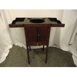 An early 20th century rectangular mahogany wash cabinet with hinged top and cupboard doors on four