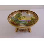 Noritake comport decorated with a landscape and gilded border on removable raised circular base with