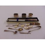 A quantity of silver and white metal napkin rings, a cased bread knife, flatware and thimbles