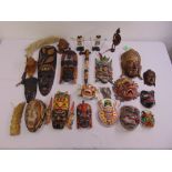A quantity of oriental and African painted and carved masks and figurines of varying style and