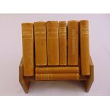 Aspreys book stand containing leather bound volumes to include an atlas, an encyclopaedia and two