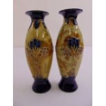 A pair of Doulton Lambethware ovoid vases decorated with stylised leaves and flowers, A/F
