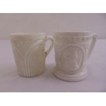 A Victorian milk glass tankard depicting Punch and Judy and another milk glass tankard (2)