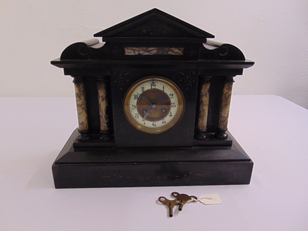 A French black marble mantle clock of architectural form to include key and pendulum