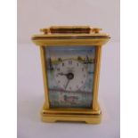 A Halcyon Days miniature brass and enamel carriage clock depicting a river scene, to include key