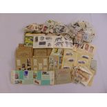 A quantity of cigarette cards, tea cards and stamps in albums and loose