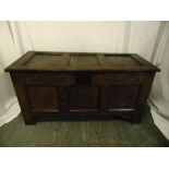 An early rectangular oak coffer with carved side panels, hinged cover and bracket feet