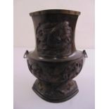 A 19th century oriental bronze vase shaped cylindrical form chased to the sides with Dogs of Foe,