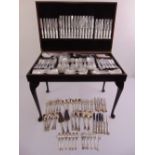 A canteen of Kings pattern flatware in fitted mahogany cabinet for twelve place settings and