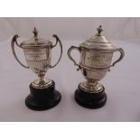 Two presentation silver trophy cups and covers on raised bases, approx weight of silver 179g (2)