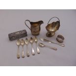 A quantity of hallmarked silver to include a cream jug, a bonbon dish, a covered box, a napkin