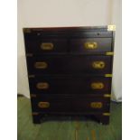 A rectangular mahogany brass bound campaign chest of drawers with inset handles and hinged top on