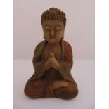 A Chinese carved wooden figurine of Guanyin in customary pose, 23cm(h)