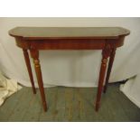 A mahogany consol table shaped oval with inlaid tooled leather top on four tapering cylindrical