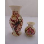 Two Moorcroft vases decorated with stylised flowers and leaves, marks to the bases, 19.5cm (h)