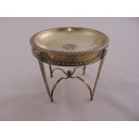 A silver wine funnel stand, circular, husk and ribbon border on four tapering rectangular legs,