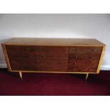 A rectangular yew wood sideboard with four drawers and two cupboards on four tapering cylindrical