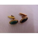 A pair of yellow gold and cabochon semi precious stone cufflinks, gold tested 14ct approx total