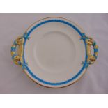 A Minton porcelain cake plate, with pierced side handles, marks to the base, 26.7cm diameter