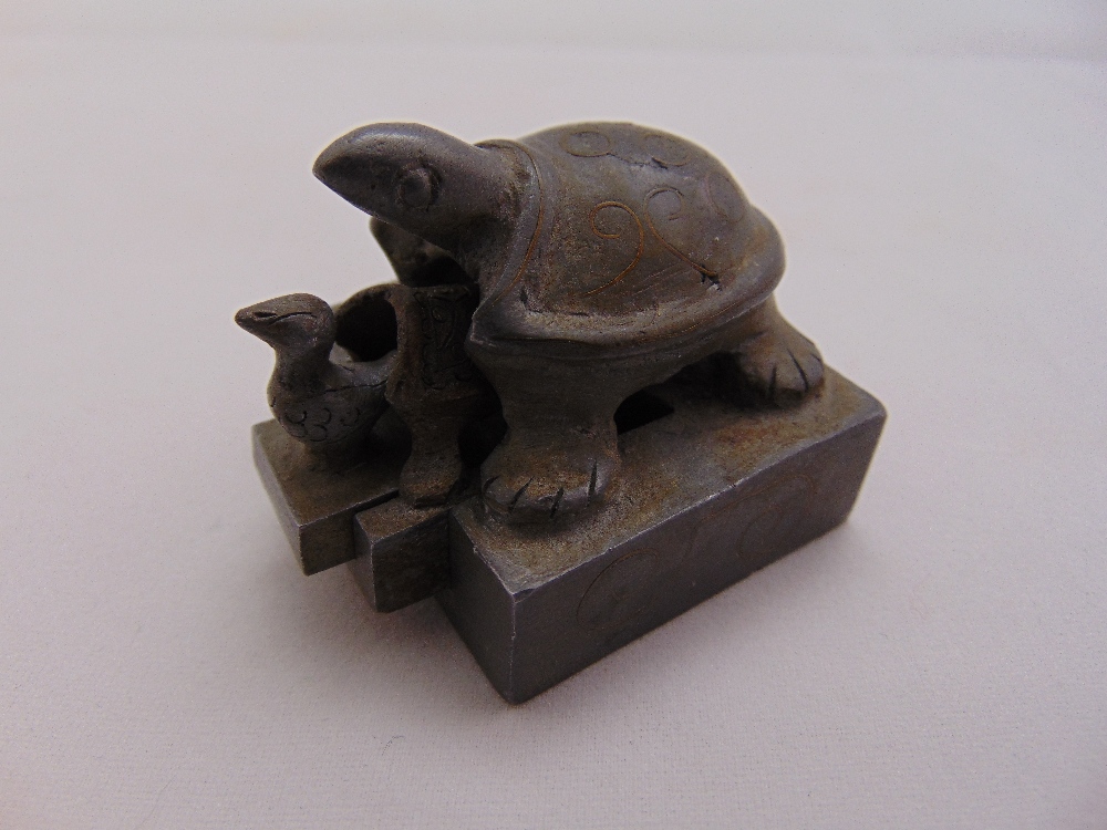 A Chinese three part metal chop seal in the form of nesting turtles