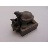 A Chinese three part metal chop seal in the form of nesting turtles
