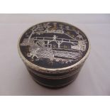 A white metal circular double sided trinket box, decorated with oriental themes to both pull-off