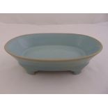 A Chinese Song style Ruware celadon oval shaped dish on four bracket feet, marks to the base, 7cm (