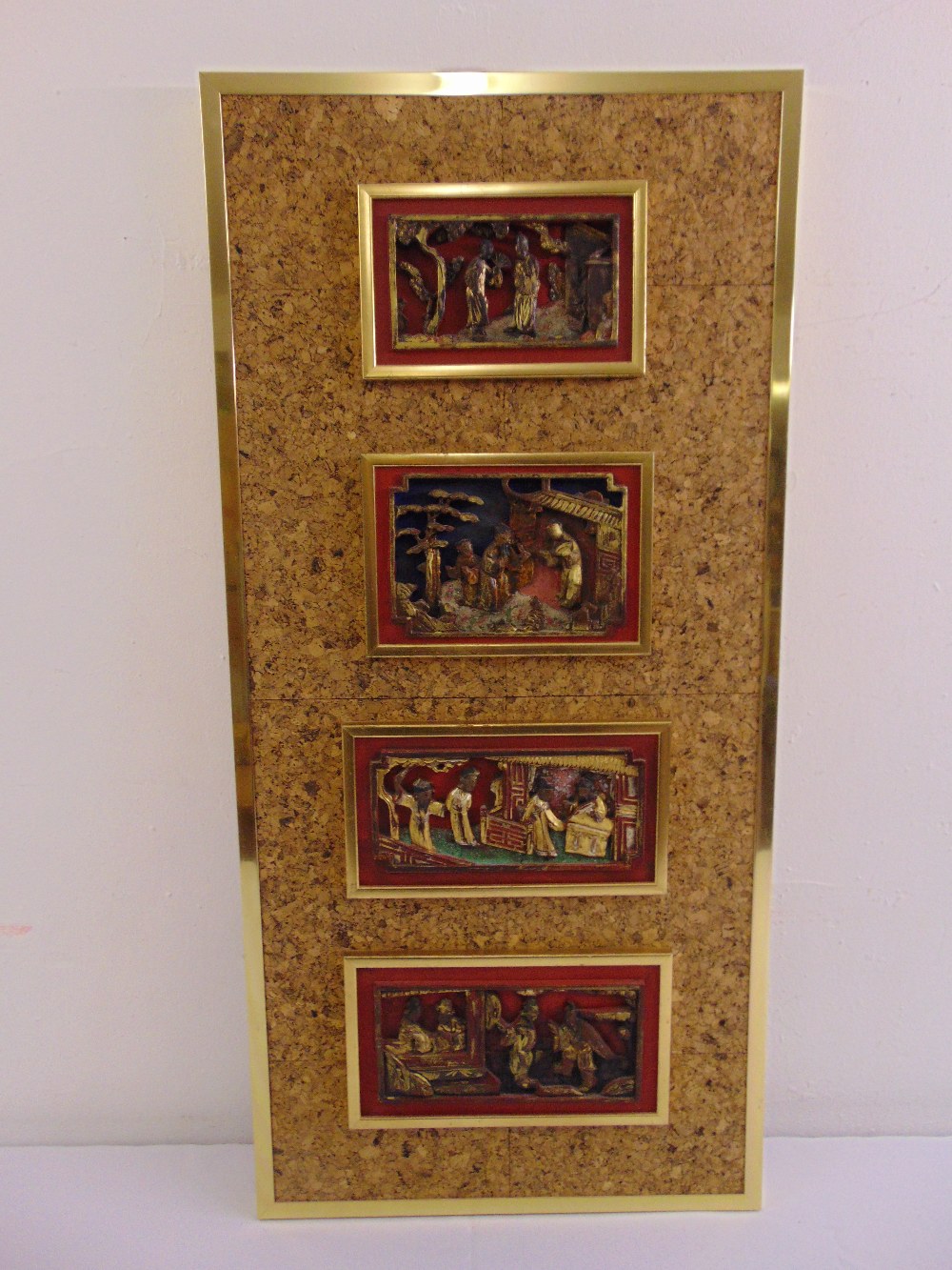 Four oriental rectangular wooden panels, the gilded figurines within architectural settings all on