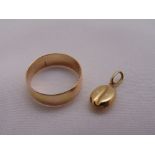 Yellow gold wedding band and a yellow gold charm in the form of a coffee bean, approx total weight