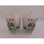A pair of Chinese famile verte ginger jars with pull off covers, the sides decorated with children