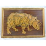 A framed leather collage mounted on a wooden panel in the form of a stylised rhinoceros, 70 x 100.